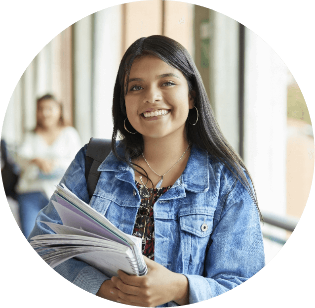 young woman holding a stack of papers and smiling